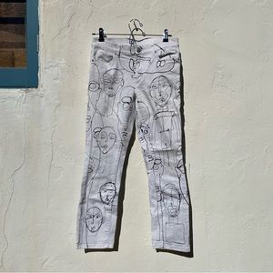White skinny jean with fine black fine art linework faces
